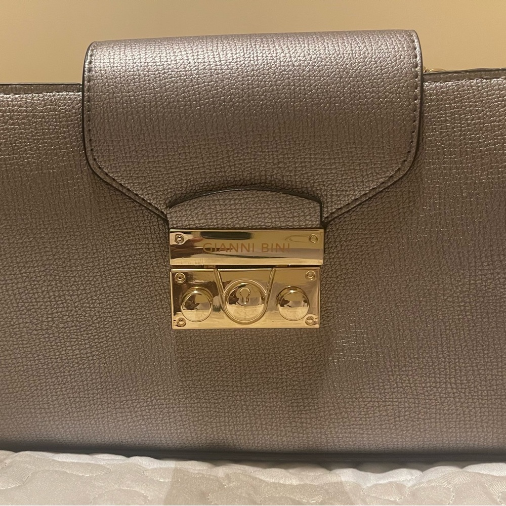 Gold Gianni Bini Purse with looped chain strap.